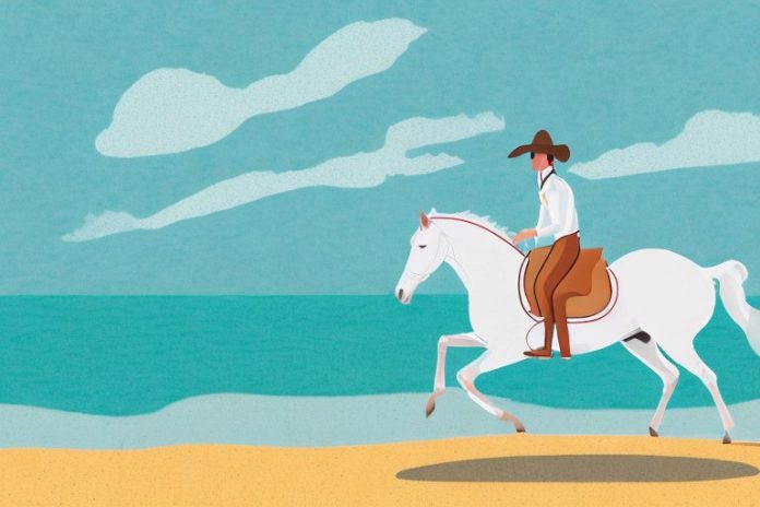 A horse and rider galloping along a beach in margate