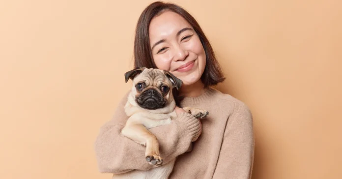 woman posing with pug. Is a Pug the Right Dog for You?